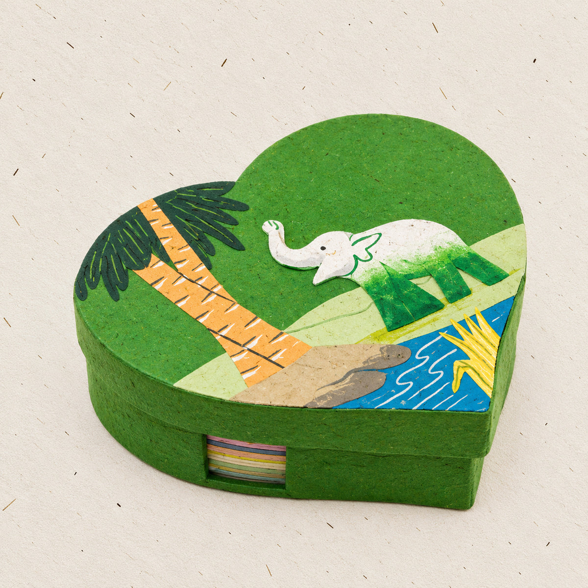 Dark green heart-shaped elephant note box with tropical landscape on natural paper background