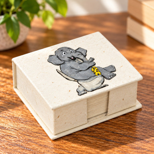 Natural cream recycled paper note box with cartoon elephant sitting on a toilet